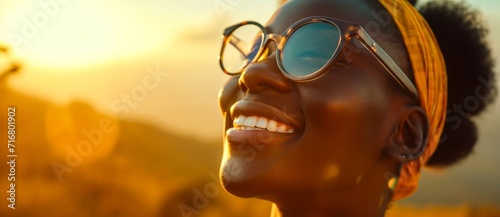 A stylish woman with a sunny disposition sporting trendy spectacles, her gaze fixed on the sky above as she confidently rocks her outdoor eyewear