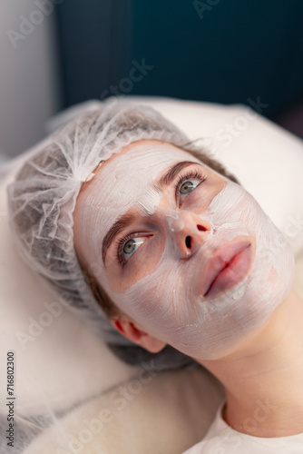 close-up of a girl's face with a cream or mask during a cosmetic procedure in a beauty salon