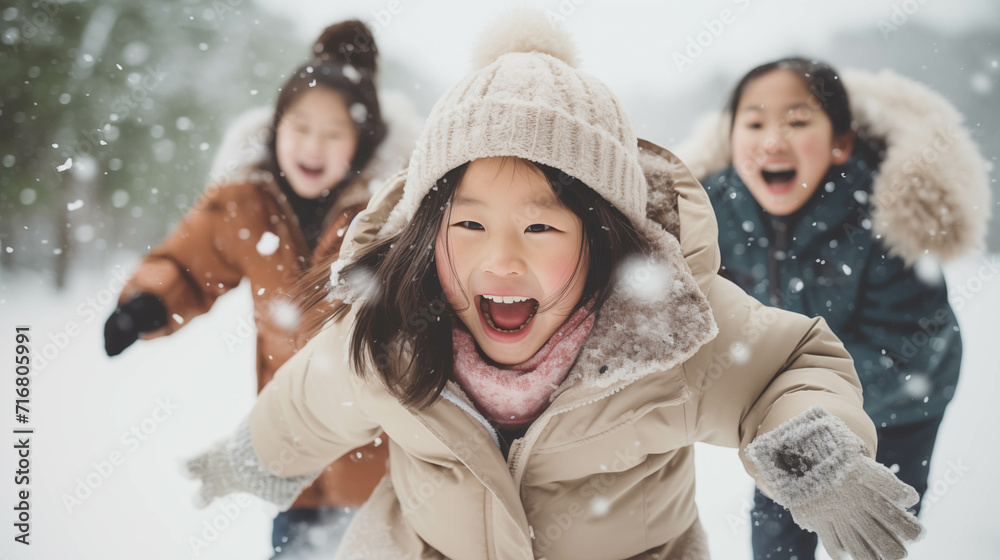 Asian family wearing coats playing in the snow. Asian family wearing coats playing in the snow.