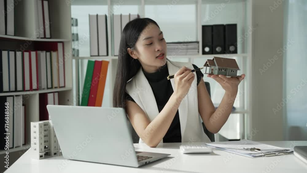 Female Asian home sales agent introduces home samples to customers online, successful female real estate agent, home sales Female Asian home sales agent introduces home samples to customers online, successful female real estate agent, home sales