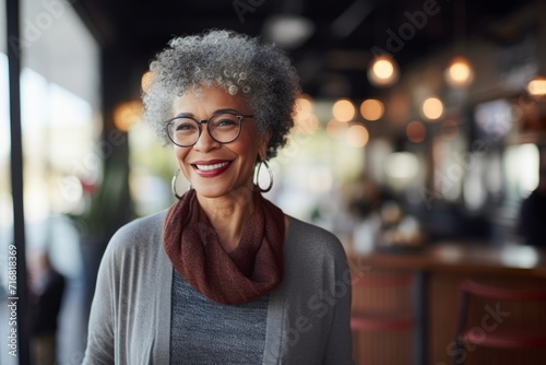 Portrait of a happy afro-american woman in her 60s wearing a chic cardigan against a serene coffee shop background. AI Generation photo