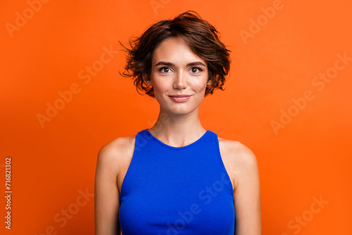 Portrait of young nice model bob brown hair girlfriend wearing blue singlet for elegant party isolated on bright orange color background