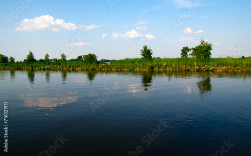 Landscape of a lake and blue sky reflected.