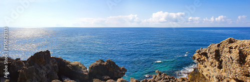 Blue sky and rock beach by the sea .