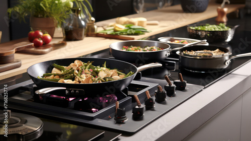 Healthy cooking on a modern induction stove with a variety of fresh vegetables in a kitchen