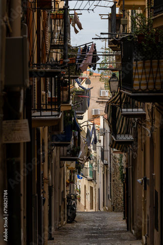 Cefalu, Sicily, Italy A shadowy alley in the historic center with balconoies.