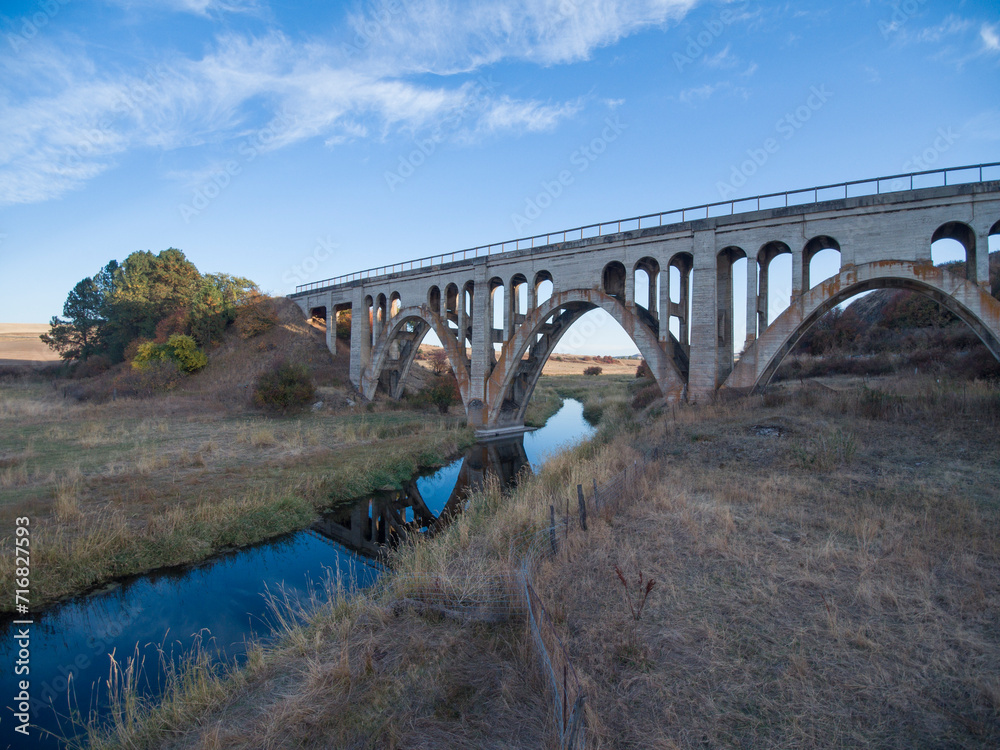 vintage railroad bridge with arches crossing a stream between Spokane washington and Lewiston idaho on the palouse prairie