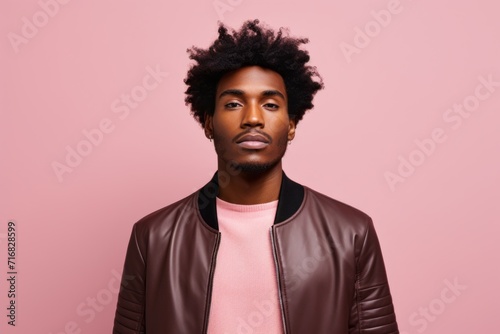 Portrait of a glad afro-american man in his 20s sporting a classic leather jacket against a pastel or soft colors background. AI Generation © CogniLens