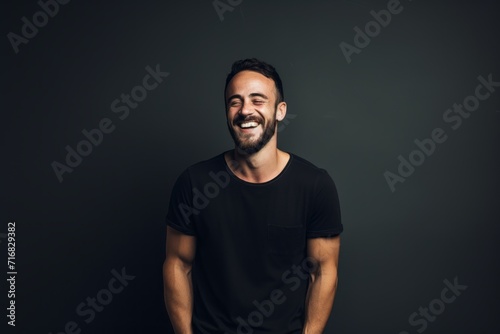Portrait of a grinning man in his 30s donning a trendy cropped top against a minimalist or empty room background. AI Generation