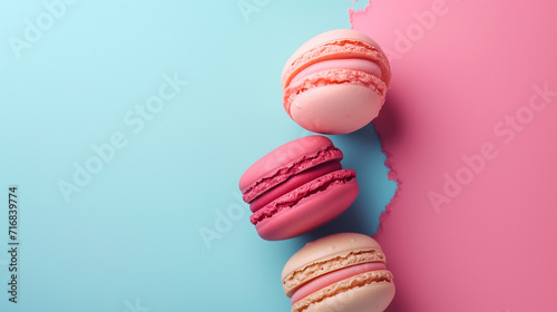 Colorful macaroons on pink and blue background