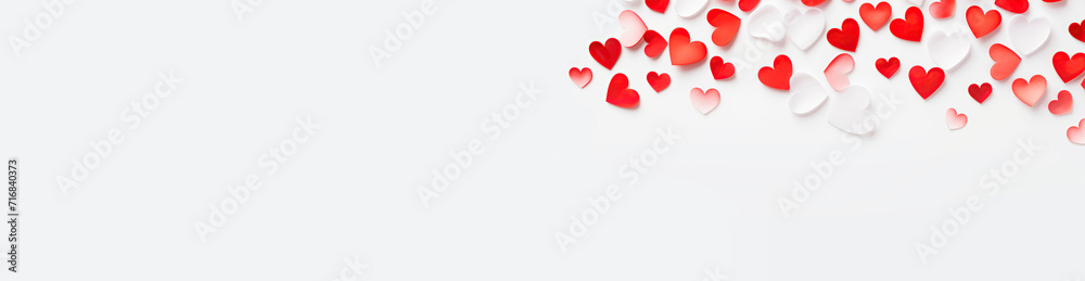 Valentine's Day. Pink and white hearts, flat lay, background with empty space. Love concept. Many decorative hearts on a white background. For postcards. Banner