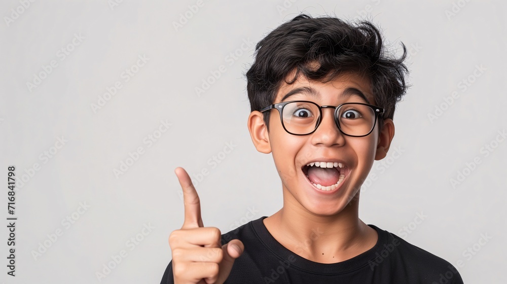 boy pointing finger towards empty space for editing isolated on light background boy pointing finger towards empty space for editing isolated on light background
