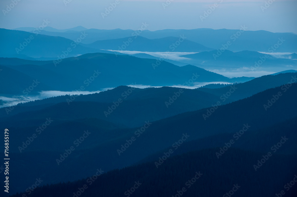 Silhouettes of blue mountain ranges. minimalist landscape in blue tones