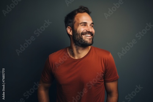 Portrait of a happy man in his 30s sporting a vintage band t-shirt against a blank studio backdrop. AI Generation