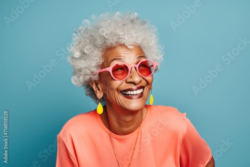 Portrait of a cheerful afro-american elderly woman in her 90s sporting a breathable mesh jersey against a blank studio backdrop. AI Generation