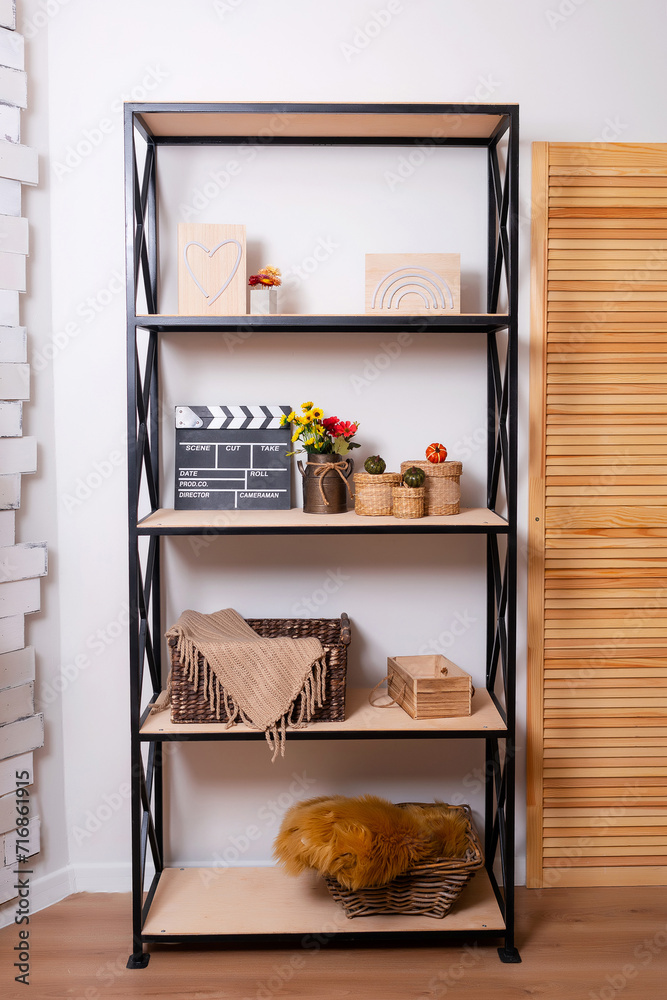 black iron shelving with wooden shelves and decor for a photo shoot. shelves with different things in the room. an open cabinet with objects in the photo studio black iron shelving with wooden shelves and decor for a photo shoot. shelves with different things in the room. an open cabinet with objects in the photo studio