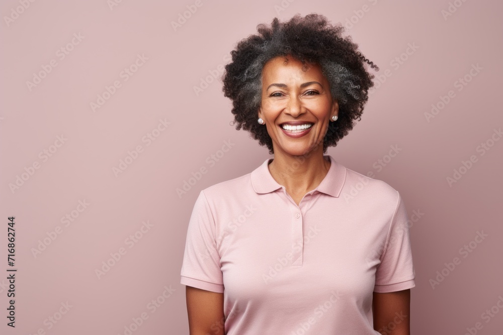 Portrait of a grinning afro-american woman in her 60s wearing a sporty polo shirt against a light wood minimalistic setup. AI Generation