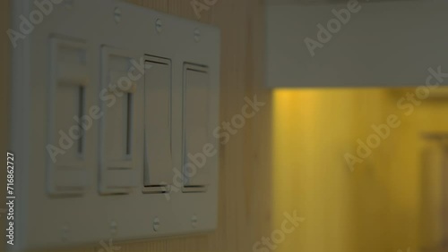 Men hand turning on light switch