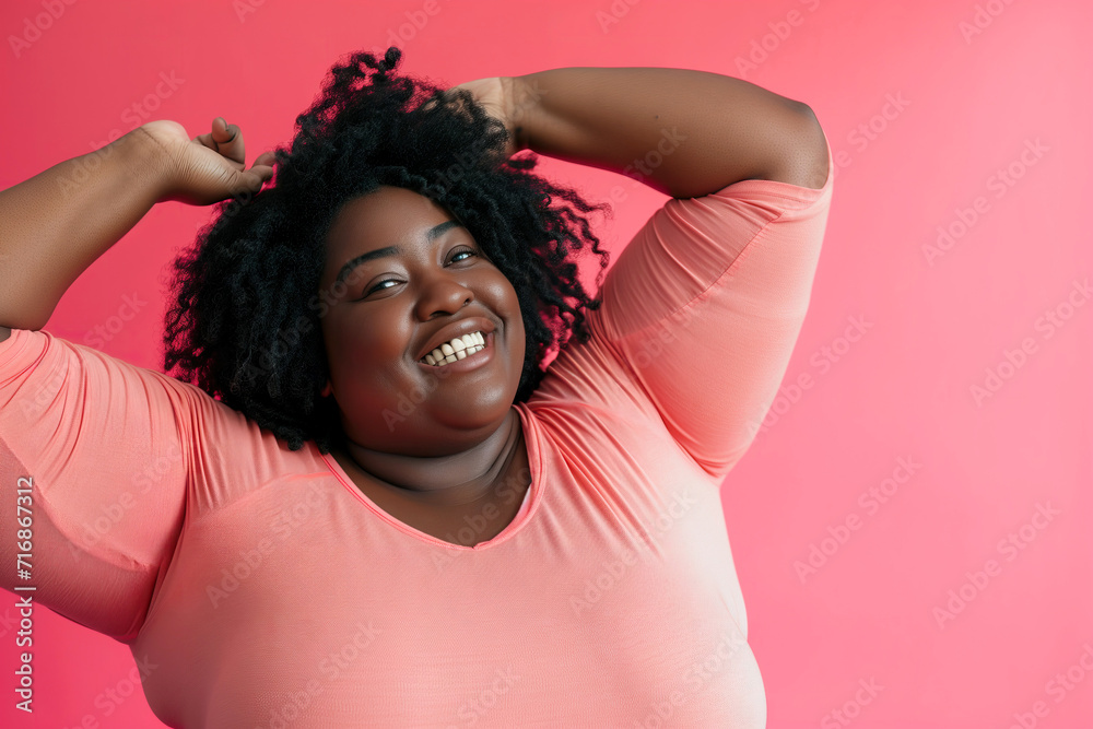 studio portrait of confident overweight happy Afro black woman on pink background studio portrait of confident overweight happy Afro black woman on pink background