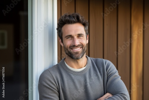 Portrait of a joyful man in his 30s showing off a thermal merino wool top against a stylized simple home office background. AI Generation