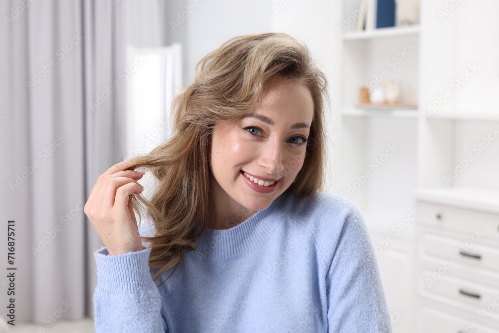 Portrait of smiling woman with curly hair at home Portrait of smiling woman with curly hair at home