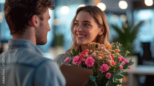 A man gives flowers to a woman. Happy birthday greetings. A man takes care of a woman.