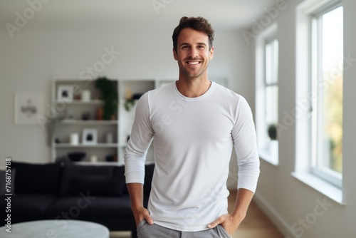 Portrait of a glad man in his 30s showing off a lightweight base layer against a crisp minimalistic living room. AI Generation © CogniLens