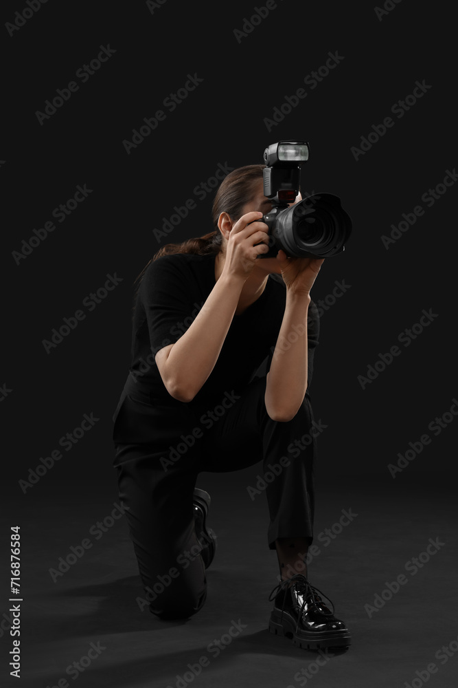 Professional photographer taking picture on black background Professional photographer taking picture on black background