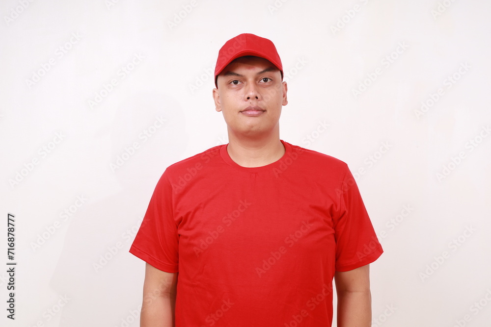 Handsome young asian courier standing against white background