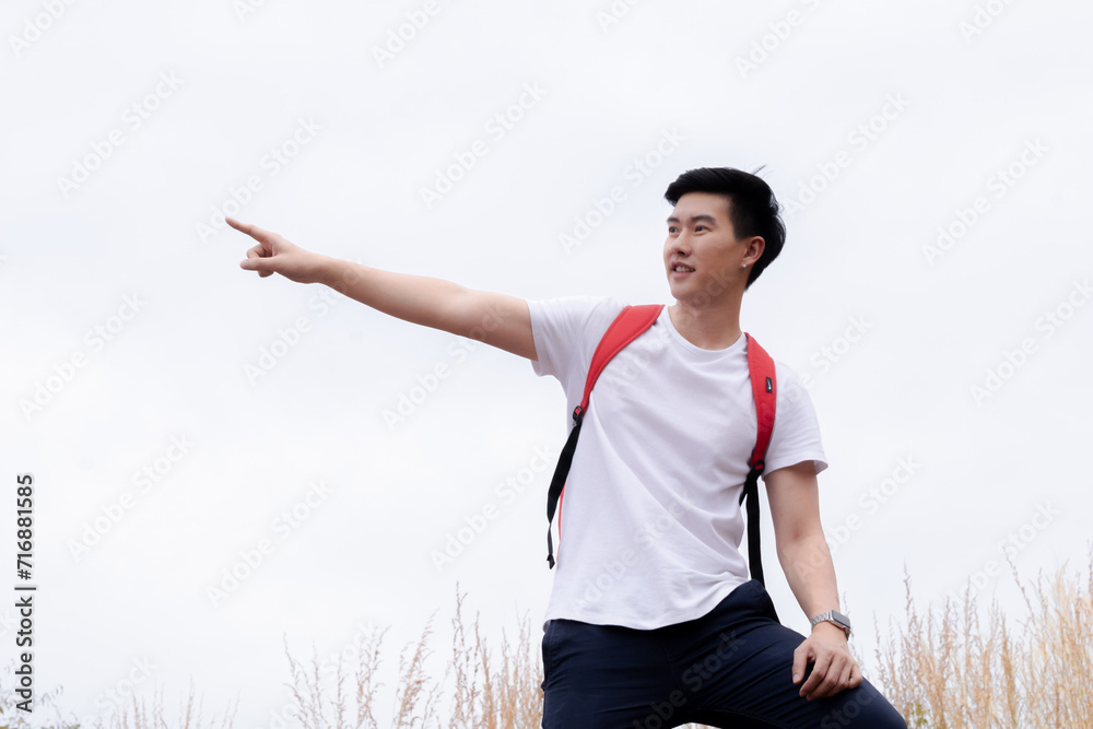 Smart Asian freelance male happy hiking walking to the top of mountain in holiday autumn vacation, backpack tourist man enjoy travel alone adventure trip activity lifestyle, healthy athletic man Smart Asian freelance male happy hiking walking to the top of mountain in holiday autumn vacation, backpack tourist man enjoy travel alone adventure trip activity lifestyle, healthy athletic man
