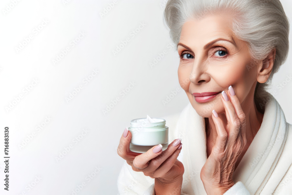 Elderly woman using face cream on solid white bright background. ai generative Elderly woman using face cream on solid white bright background. ai generative