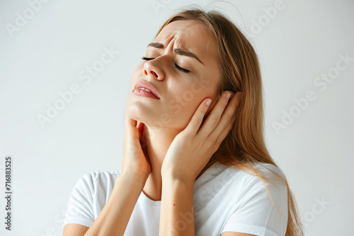 Frustrated female feeling neck discomfort, white backdrop