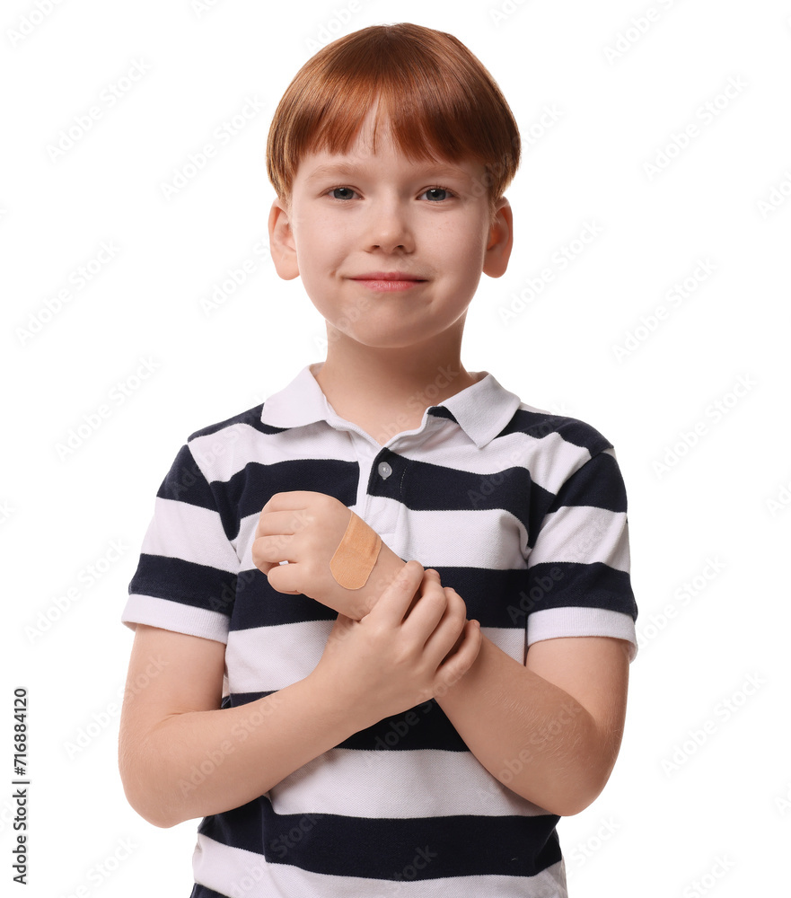 Little boy with sticking plaster on hand against light blue background Little boy with sticking plaster on hand against light blue background