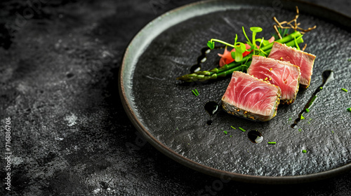 Creative Michelin-starred bluefin tuna with tuna green asparagus, black ceramic tableware, and rustic Japanese style. cinematic.