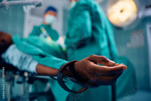 Close up of black patient under anaesthetic during surgery in hospital.