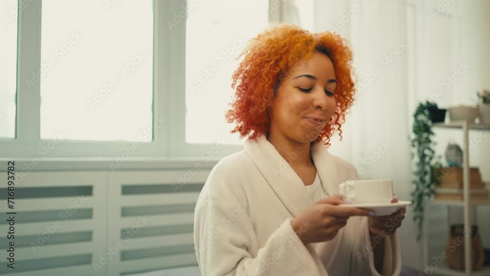 Relaxed African American woman enjoying cup of coffee, pleasant morning rituals