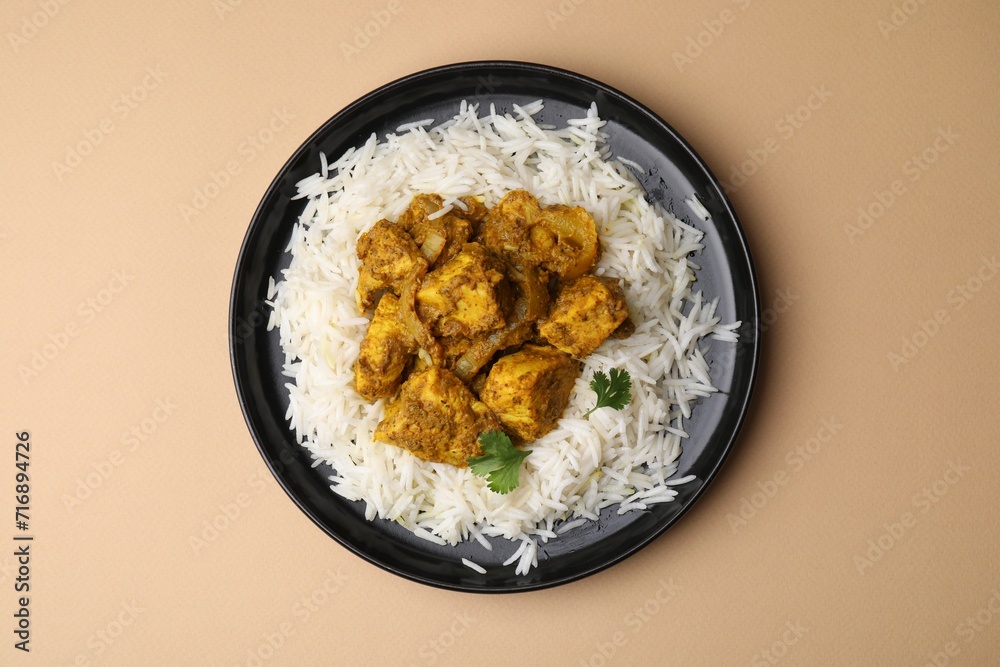 Delicious chicken curry with rice on beige background, top view Delicious chicken curry with rice on beige background, top view