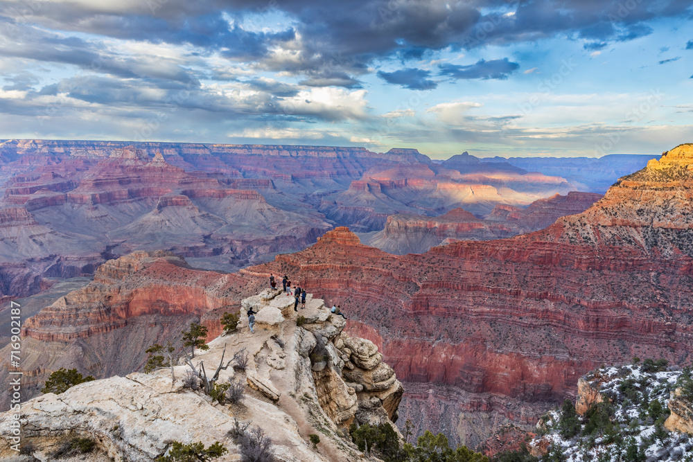 People admire the incredible sunset views of Grand Canyon National Park, Northern Arizona, USA.