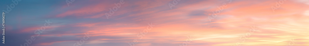 Pastel Vibrant extra wide panoramic sky. Fantasy banner sky. Rich colors. Daytime sunset beauty. Fiery glowing heavenly sky with gradient colors. Red, pink, orange, blue, yellow.