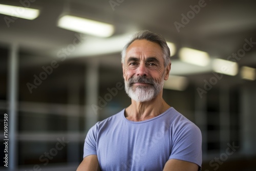 Portrait of a relaxed mature man practicing ballet in a studio. With generative AI technology
