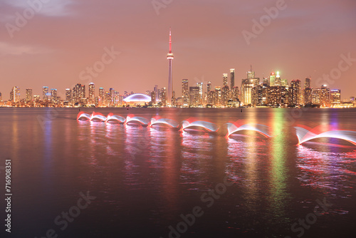 long exposure of a kayaker in front of the night skyline of Toronto