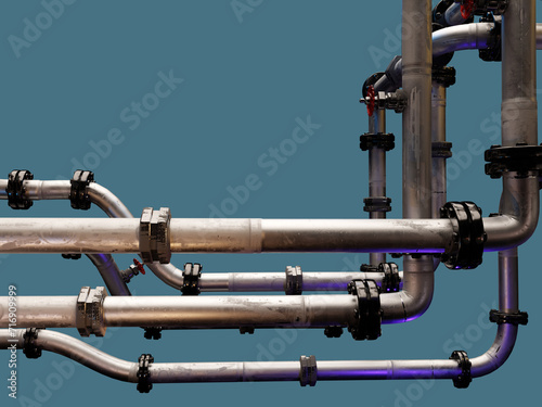 Industrial pipes of various diameters; metallic conduits form a fragment of a chemical production site.  photo