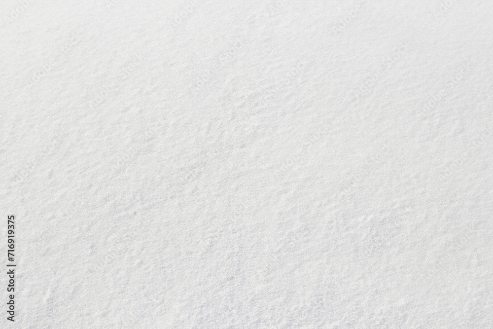 Uniform snow cover. Snow texture on a flat plot of land Uniform snow cover. Snow texture on a flat plot of land