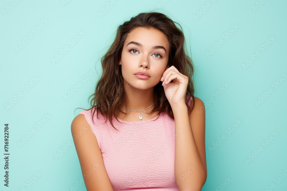 Photo of admiring young pretty girl brown hair wear pink crop top touch finger chin dreams look novelty isolated on cyan color background Photo of admiring young pretty girl brown hair wear pink crop top touch finger chin dreams look novelty isolated on cyan color background