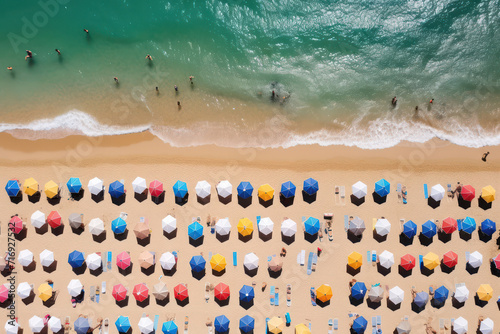 Sandy Bliss: A Majestic Aerial View of Crowded Beachgoers Enjoying a Beautiful Summer Day on a Turquoise Coastline.