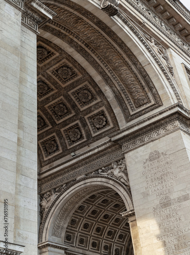 Detail under view of carvings under the arch of the Triumphal Arch. View from the famous Arc de Triomphe, Iconic touristic architectural landmark of Paris, Selective focus. © num