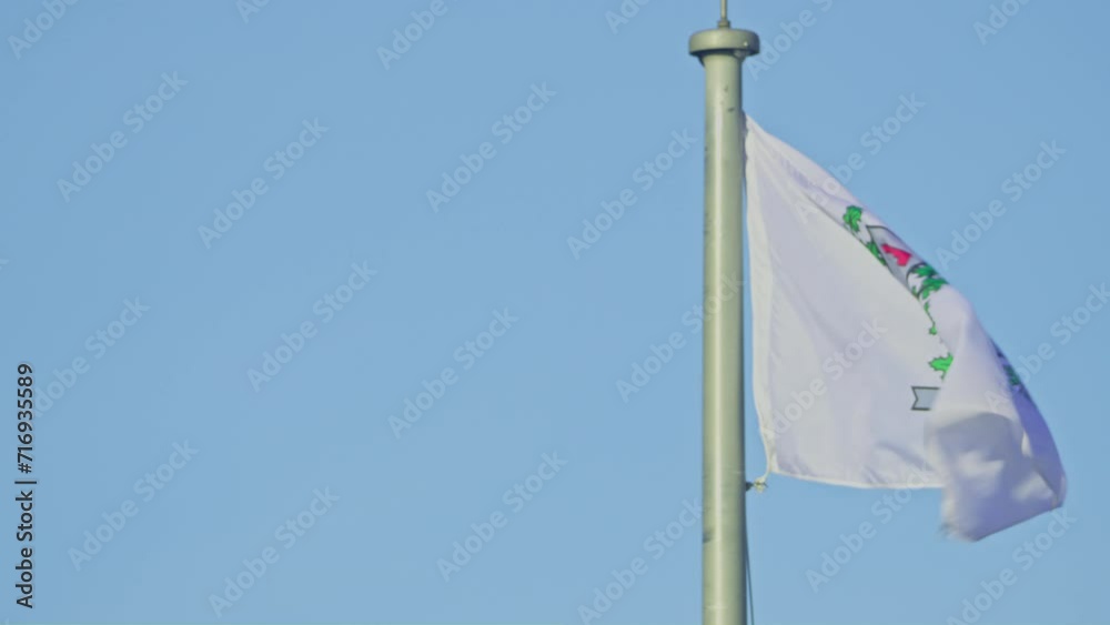 Matane flag alone paning right in wind blue sky Matane flag alone paning right in wind blue sky
