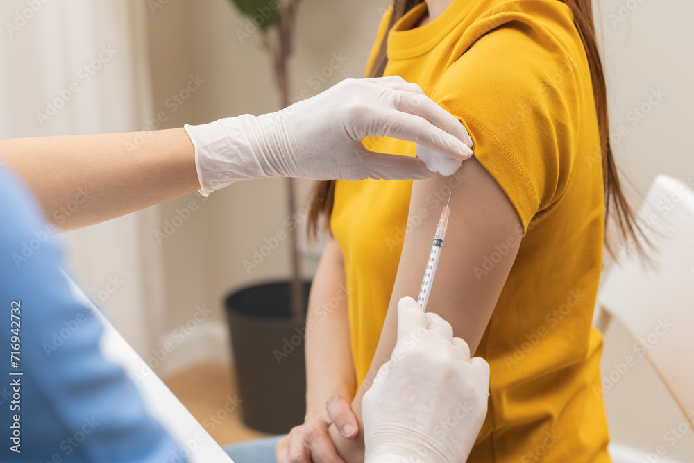 Health care, corona virus, hand of woman nurse, doctor giving syringe vaccine, injection dose on arm sick patient at clinic. Vaccination, immunization disease prevention against flu pandemic influenza - obrazy, fototapety, plakaty 