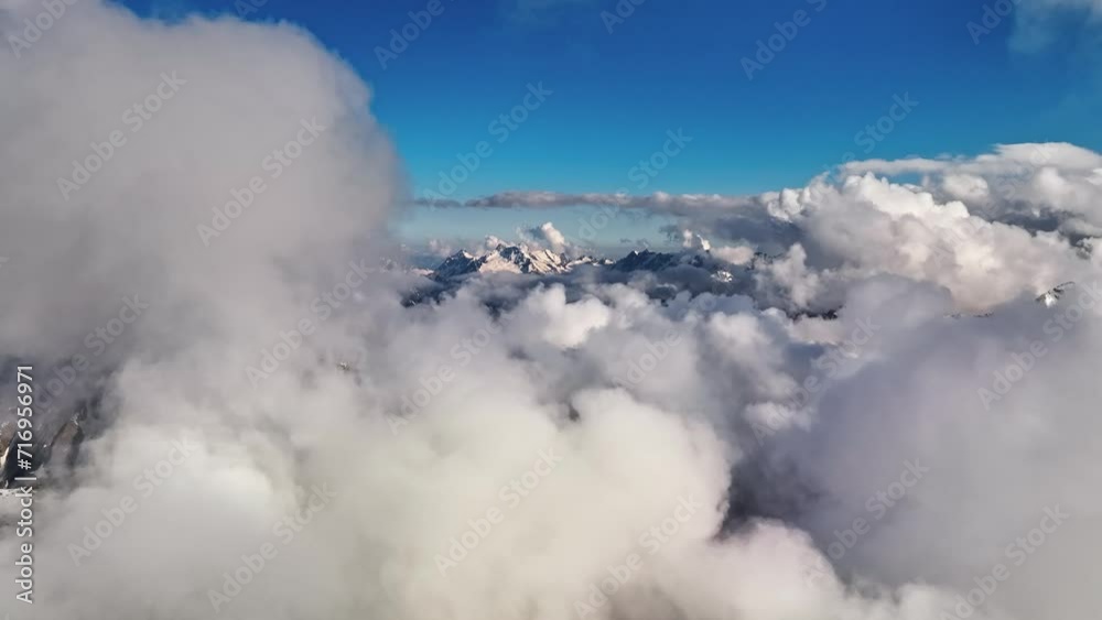 Flight in the clouds of vertical development over the mountains during the day. Aerial view between the clouds, horizon-stabilized image from a drone. Time lapse. Weather video background Flight in the clouds of vertical development over the mountains during the day. Aerial view between the clouds, horizon-stabilized image from a drone. Time lapse. Weather video background