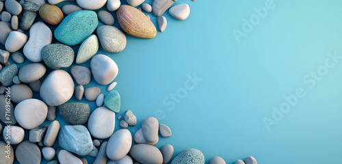 Assorted pebbles lined up against a light blue gradient background, peaceful and calming.